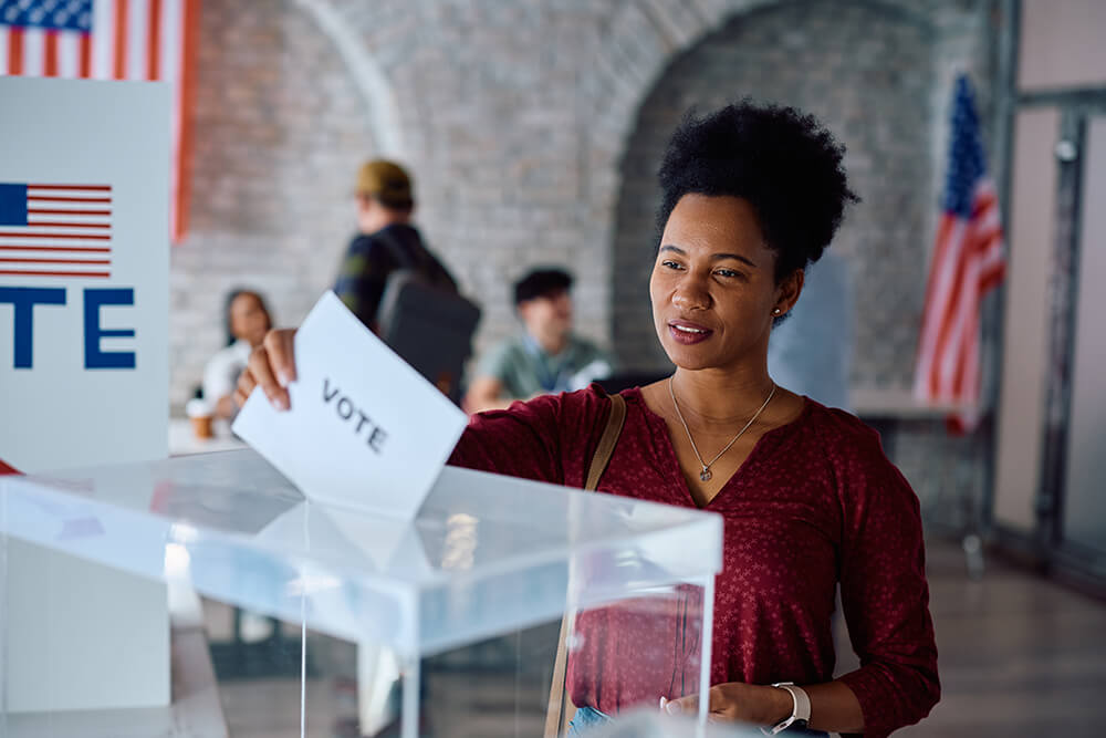 A photo of a young woman under the age of 40 casting her ballot in the Youngstown city election