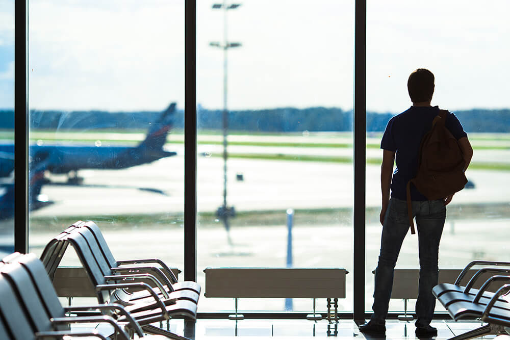 a man waiting for his flight while watching planes take off at Youngstown Regional Airport