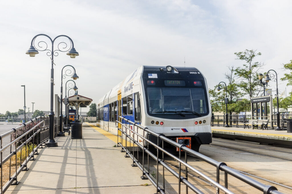 a public transportation passenger train arriving at a station.